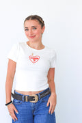 Woman wearing a white t-shirt with a red logo and blue jeans on a white background