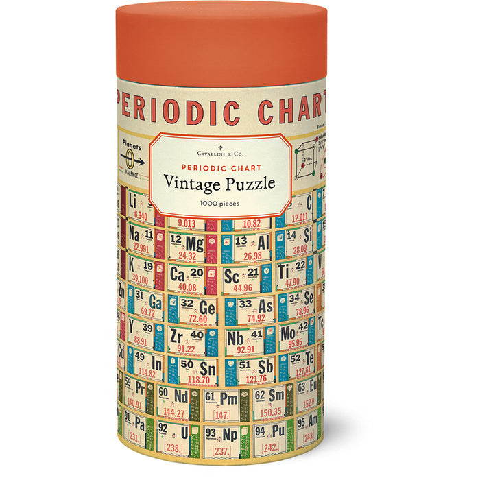 The Cavallini & Co. Periodic Chart 1,000 Piece Jigsaw Puzzle comes in a cylindrical container with an orange lid and features a vintage periodic chart design.