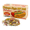 The Portillo's Hot Dog | 500 Piece Jigsaw Puzzle by Transit Tees features a Chicago-style hot dog illustration on the box, with loose puzzle pieces displayed in front.